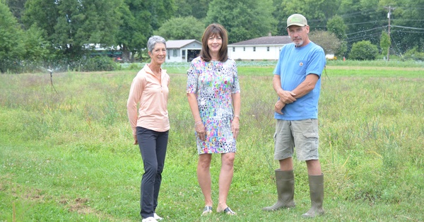 Mark Printz (right), Canticle Farm manager and head farmer shows the overhead irrigation system purchased by a CRCF Community Fund grant to Lucy Benson (left), CRCF grant allocations committee chair, and Karen Niemic Buchheit (middle), CRCF executive director. 